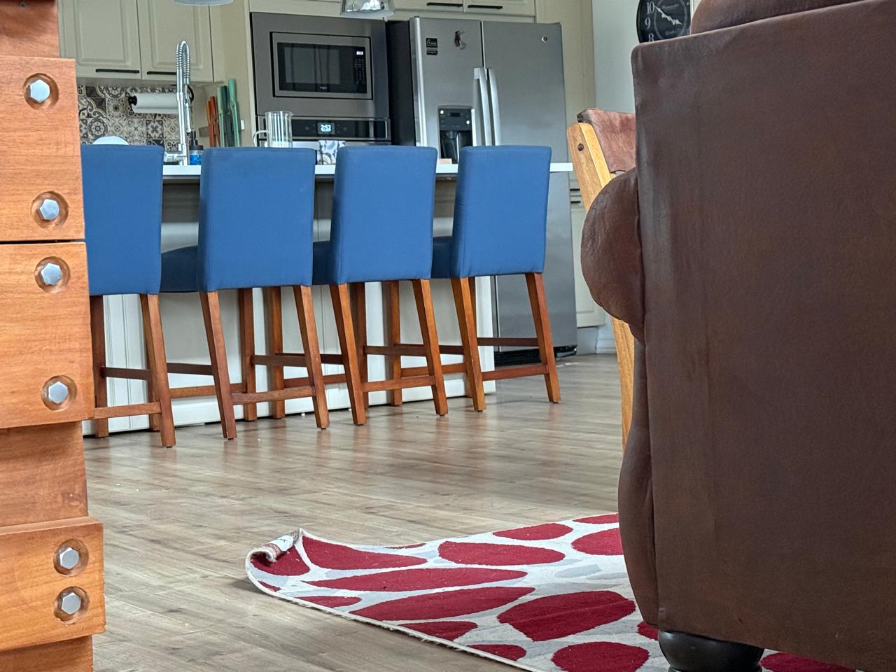 Modern kitchen and dining area with secured rugs