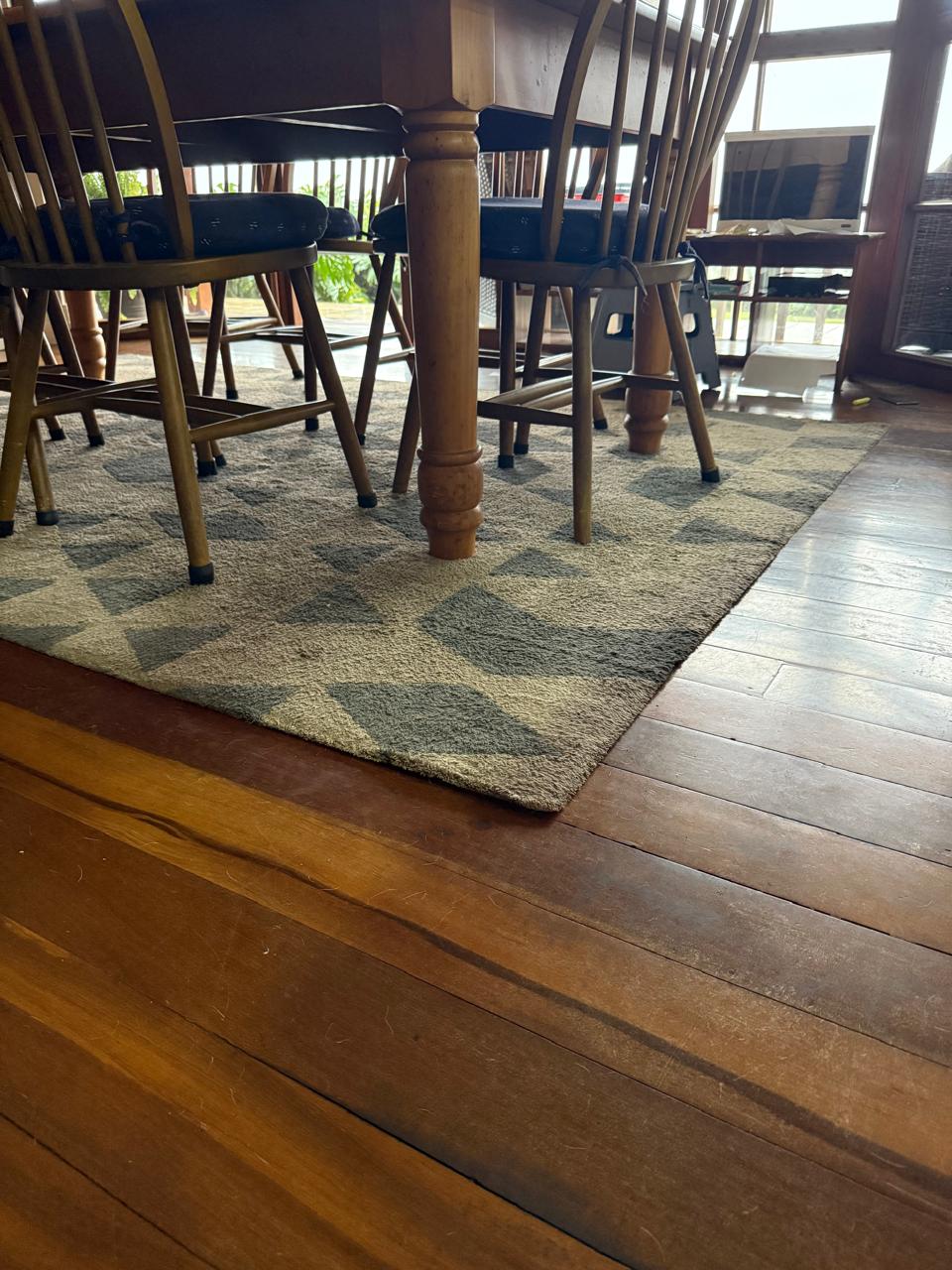Dining area with secured rug under table and chairs